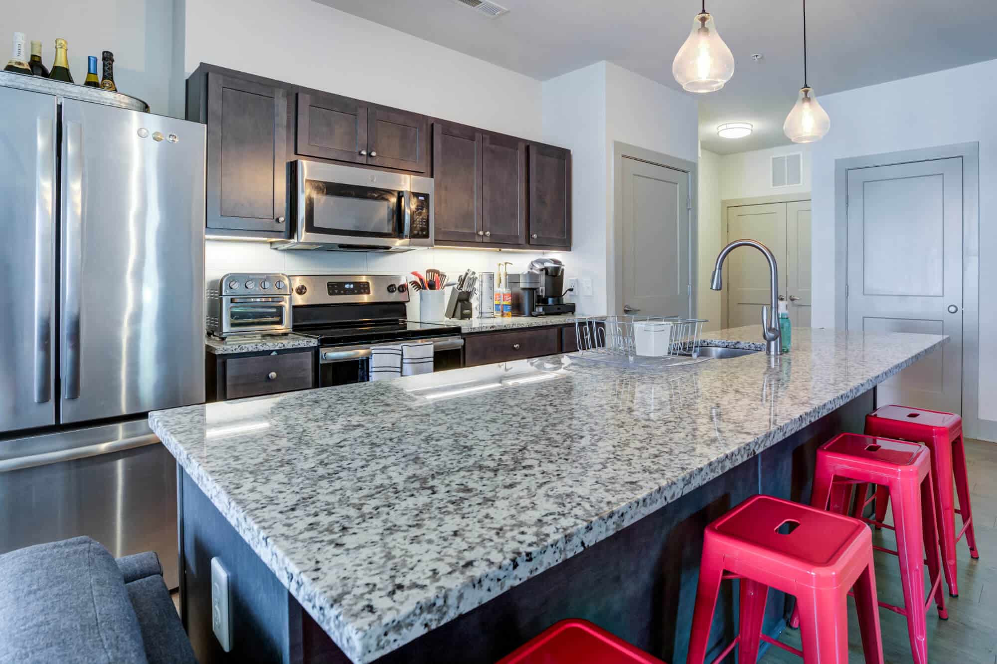 1820 at centennial off campus apartments near nc state university raleigh north carolina kitchen with kitchen island bar stool seating granite countertops